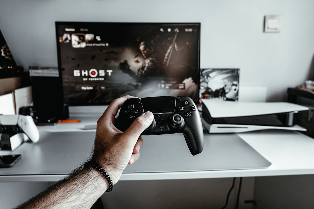 a-person-holding-a-video-game-controller-in-front-of-a-tv-vp6dsrglyny